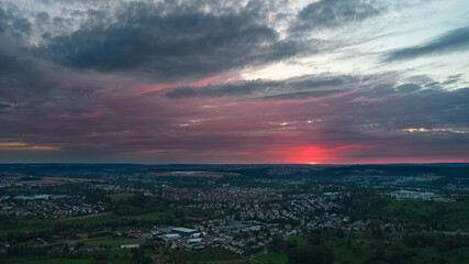 Fototapeta na wymiar Aerial view of a german city near stuttgart. Sunset with beautiful cloudy sky. Germany, Nurtingen.