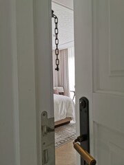 The door leading to the bedroom. Door chain in the doorway. 