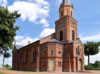 Fototapeta premium A brick chapel and a Roman Catholic church of St. Michael the Archangel built at the turn of the 19th and 20th centuries in Jabłonka Kościelna in Podlasie, Poland.