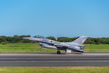 A modern American military aircraft, with missiles, takes off in a tactical operation, on the runway.