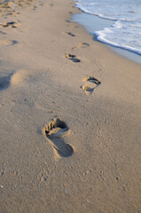 Human footprints on the sandy beach in Spain