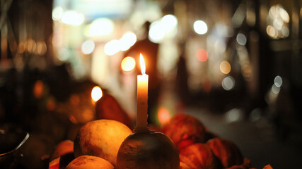 Burning Candle on Fruit at night during power outage.