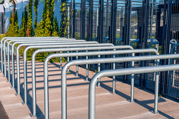 Fototapeta na wymiar Metal railings in front of gates of Silesian Stadium in Chorzów, Poland. Row of steel rails. Entrance to the sport arena.