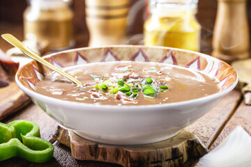 typical Brazilian bean broth, bean soup with bacon, pepperoni, green aroma, onion and chopped vegetables