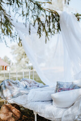 Photozone canopy bed in the forest in nature. the fabric flutters in the wind. Place for a photo of the bride. photo session