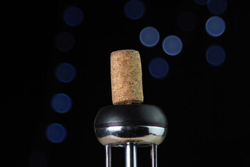 Wine cork on a corkscrew on a dark background
