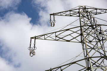 power pylon without power wires with blue sky as background, view from below