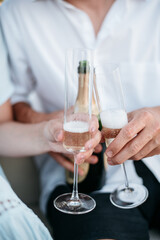 Hands holding champagne toasting for engagement celebration