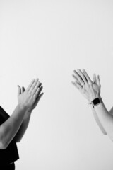 closeup of hands clapping or praying against white backdrop with empty space