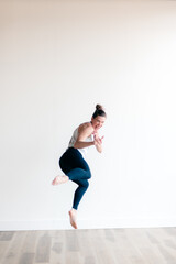 woman kickboxing jumping in yoga studio exercising 