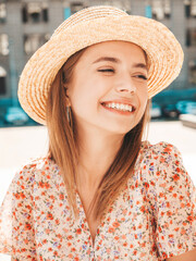 Young beautiful smiling hipster woman in trendy summer dress. Sexy carefree woman posing on the street background in hat at sunset. Positive model laughing outdoors. Cheerful and happy