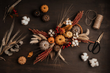 Diy rustic autumn table decoration.  Floral interior decor for fall holidays with handmade pumpkins. Flatlay, top view.