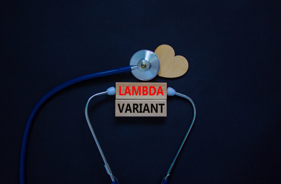 Covid-19 lambda variant strain symbol. Wooden blocks, words lambda variant, stethoscope, black background. Wood heart. Medical and covid-19 lambda variant strain concept, copy space.