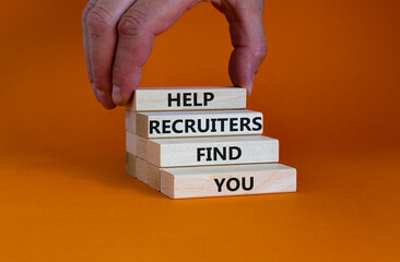 Help recruiters find you symbol. Concept words 'Help recruiters find you' on wooden blocks on a beautiful orange background. Businessman hand. Business, human resources concept.