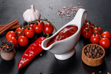 Red sauce or ketchup in a bowl and ingredients for cooking
