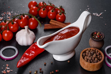 Red sauce or ketchup in a bowl and ingredients for cooking