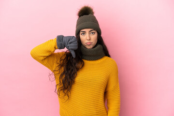 Young caucasian girl with winter hat isolated on purple background showing thumb down with negative...