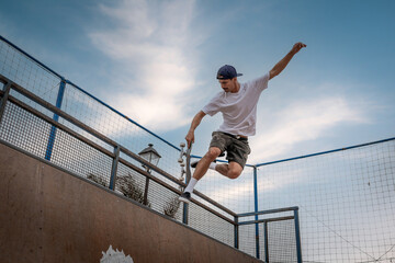young man skateboarding on the ramp of a skate park