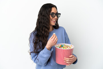 Young caucasian woman isolated on white background with 3d glasses and holding a big bucket of popcorns