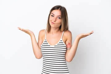 Young Romanian woman isolated on white background having doubts while raising hands