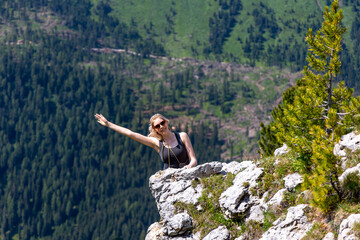 Carefree blonde female tourist enjoying her holiday in the dolomite mountains