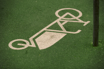 cargo bike symbol painted on green asphalt at a dedicated load bike parking slot - modern city...
