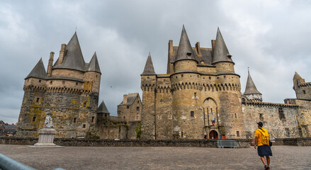 A young tourist at the medieval castle of Vitre. Ille-et-Vilaine department, Brittany region, France