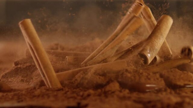 Cinnamon falling Into cacao powder . Spices . Shot on RED EPIC DRAGON Cinema Camera in slow motion .