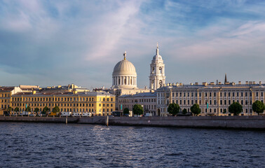 Fototapeta na wymiar View from Tuchkov Bridge to the Makarov embankment and the domes of the Church of St. Catherine the Great Martyr on Vasilievsky Island in St. Petersburg