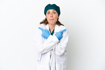 Surgeon caucasian woman in green uniform isolated on white background pointing to the laterals having doubts
