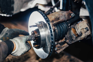 installation of a new brake disc in a car, repair of a brake system in a car service.