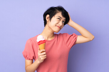 Young Vietnamese woman with short hair holding a cornet ice cream over isolated purple background...