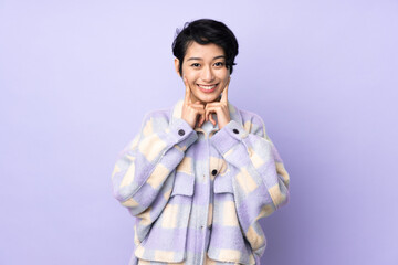 Young Vietnamese woman with short hair over isolated background smiling with a happy and pleasant expression