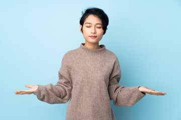 Young Vietnamese woman with short hair over isolated background having doubts