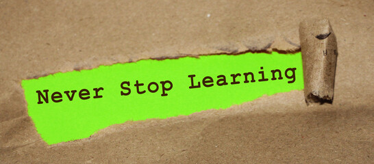 Brown torn Paper and yellow background with never stop learning written