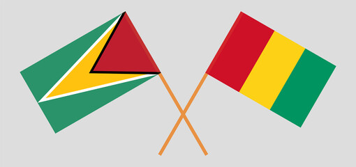 Crossed flags of Guyana and Guinea. Official colors. Correct proportion
