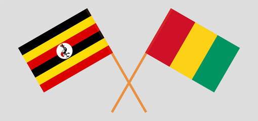 Crossed flags of Uganda and Guinea. Official colors. Correct proportion