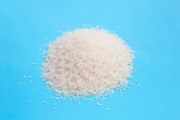 Raw rice on blue background.