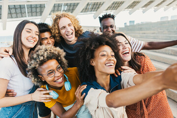 International group of young multicultural people taking selfie portrait with smart phone - Best friends having fun together on holidays - Friendship lifestyle and unity concept - Focus on afro woman