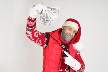 Santa Claus is holding money in his hands, feeling joy.