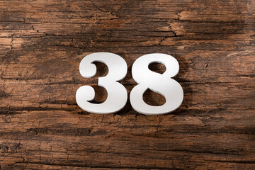 thirty eight 38 - White wooden number on rustic background