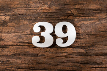Obraz premium Number thirty nine 39 - White Piece on Rustic Wood Background