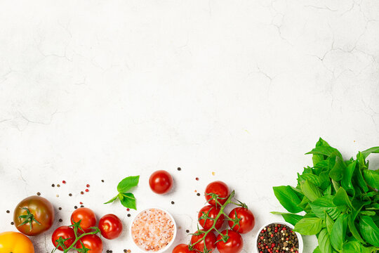 Set of vegetables, herbs and spices on white marble background top view. Recipe book cover concept.