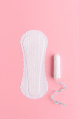 Woman sanitary pad with tampon on pink background. Flat lay. Gynecology and hygiene concept and cleanliness of woman.