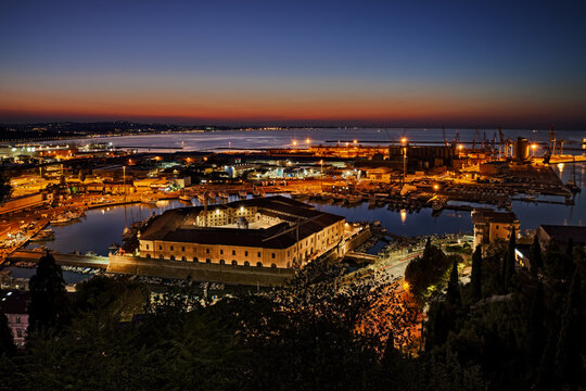 Ancona, Marche, Italy: night landscape of the port for the small boats and fishing vessels with the pentagonal Mole Vanvitelliana, built on 18th-century as a lazzaretto quarantine station
