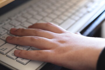 a woman with her hands on the computer keyboard and mouse