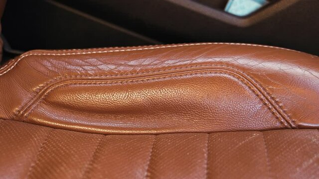 Brown leather seat in a classical American muscle car. Used seat.