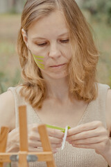 Young woman with green tapes on face. Face aesthetic taping. Attractive young woman with kinesiology tapes on forehead. Beautiful Woman With Kinesiology Facelift Tapes