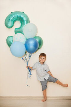 Boy with the number three and the ballons for his birthday