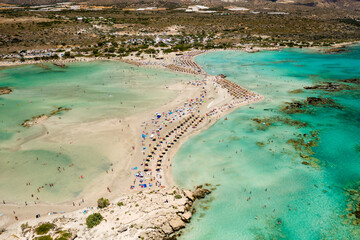 Fototapeta na wymiar Aerial view of a beautiful narrow sandy beach and shallow, warm lagoons (Elafonissi Beach, Crete)